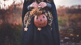 kid holding pumpkin